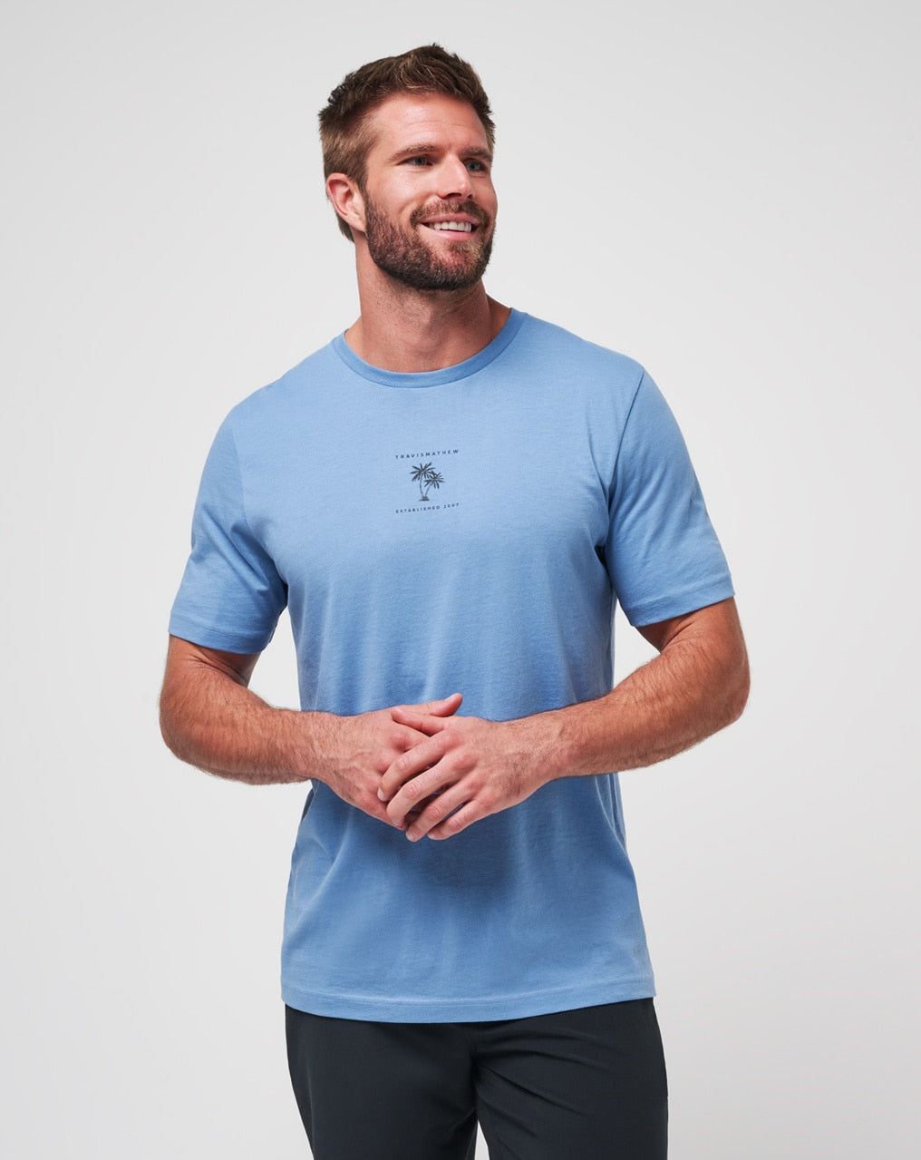 Blue t-shirt with palm tree design and text, likely made of cotton or polyester blend.