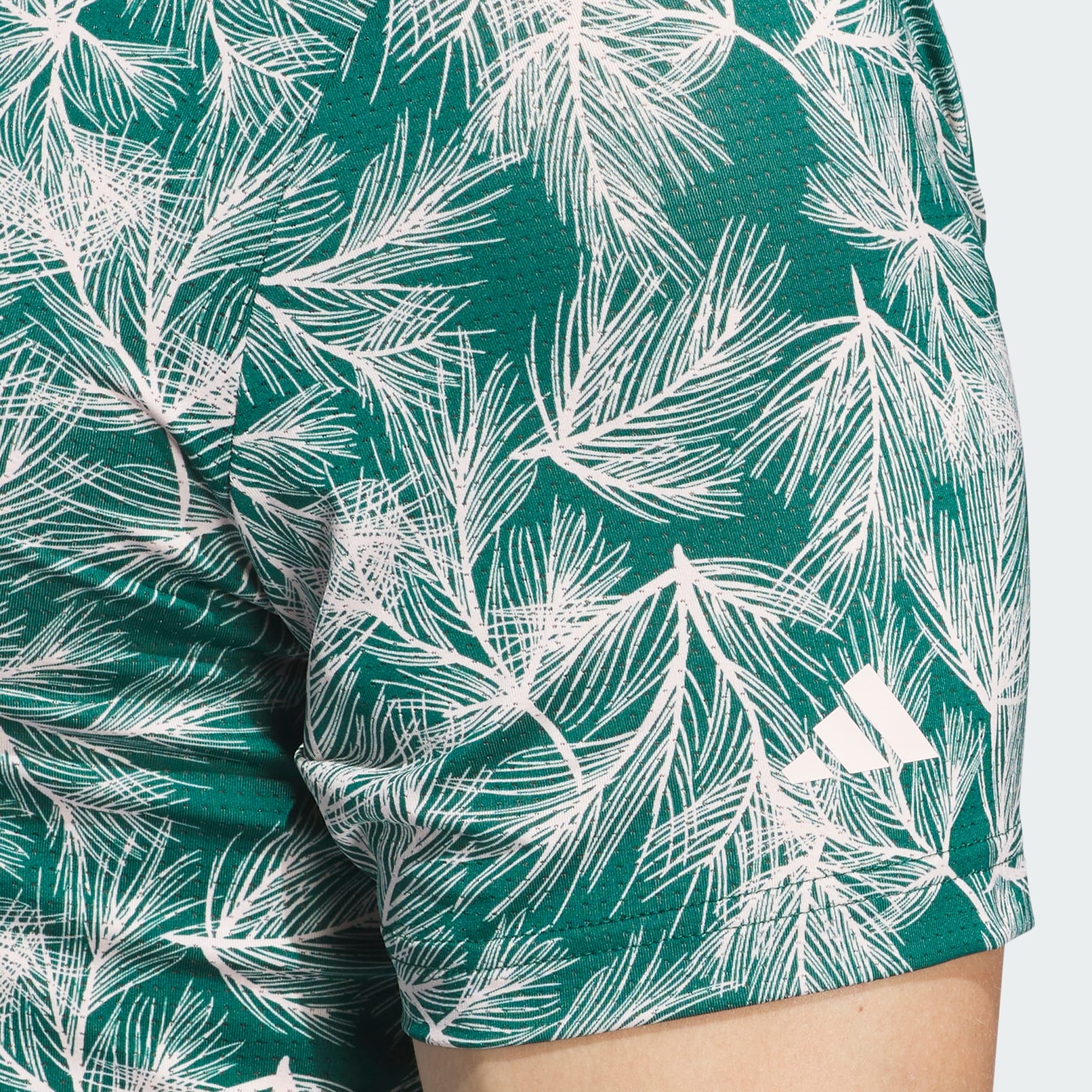 Green palm leaf print adidas shorts.