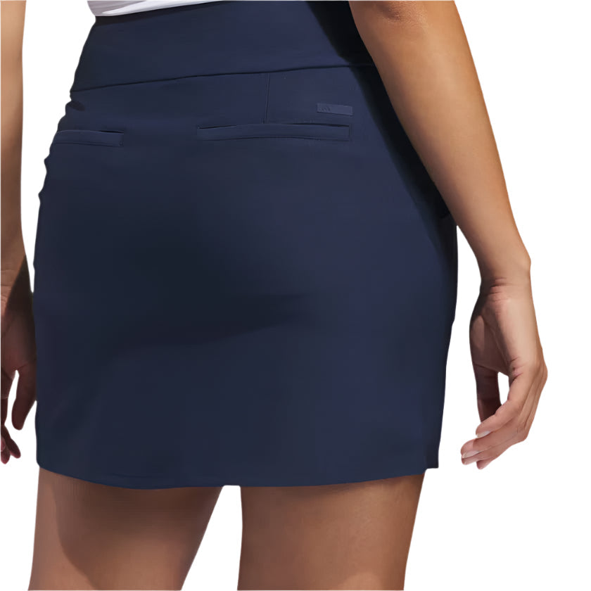 Navy blue golf skirt with pockets and a stretchy waistband, likely made of polyester or spandex.