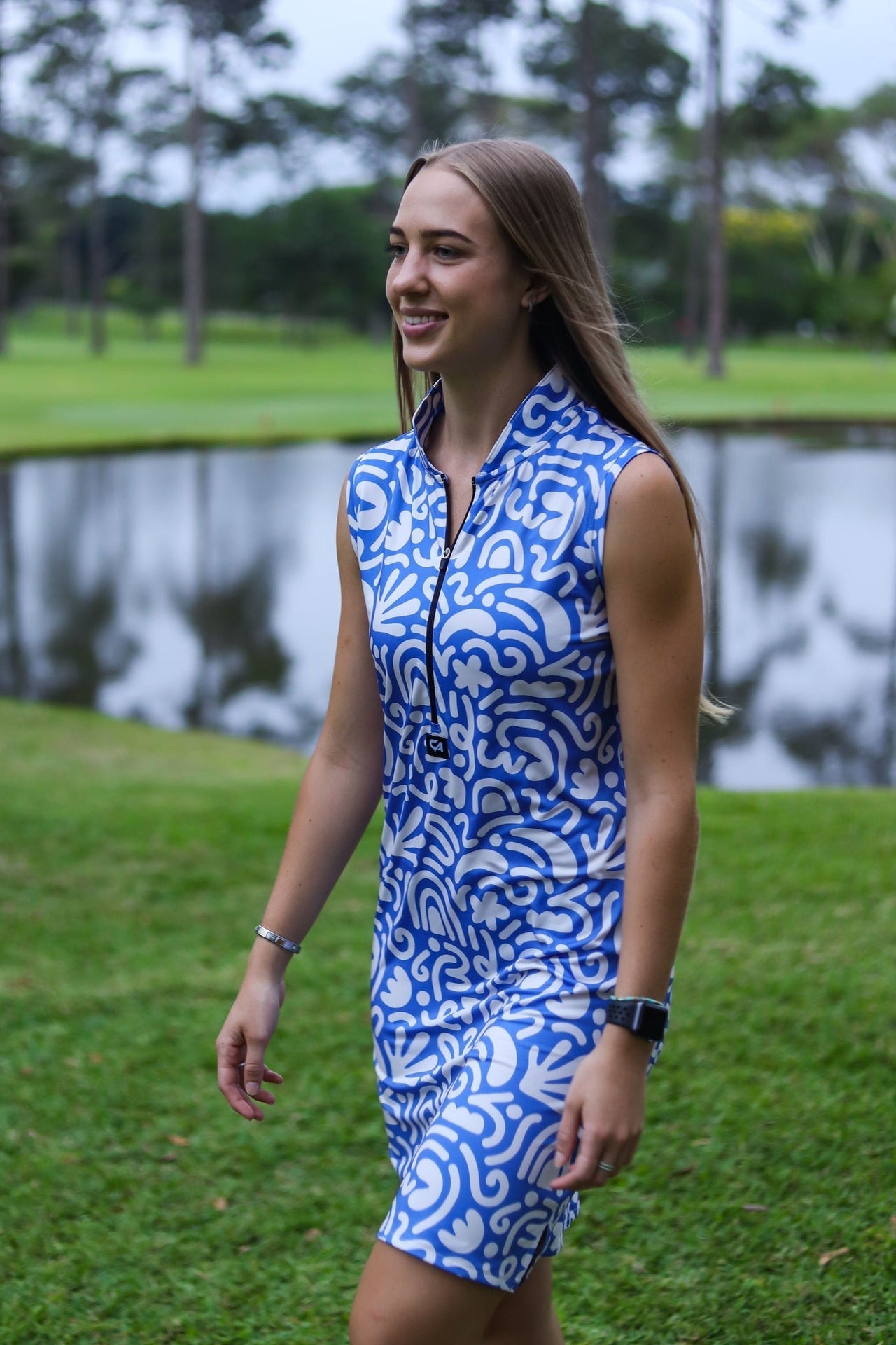 Blue and white patterned sleeveless dress with zipper detail at the neck.