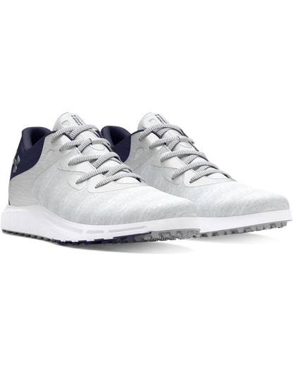 White golf shoe with navy accents and silver laces, designed for comfort and performance.
